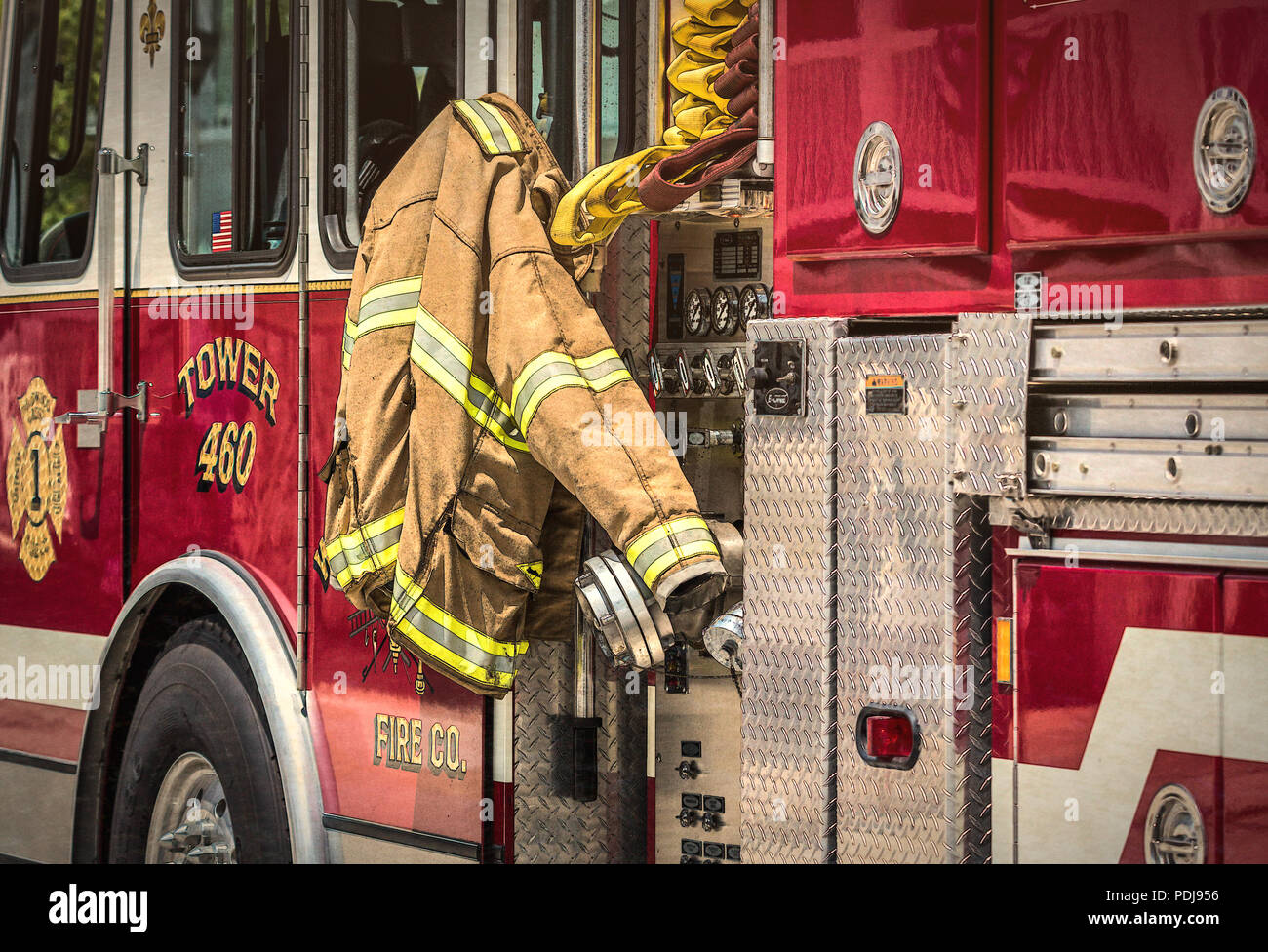 Hero at work-Firefighter Gear hanging on the side of a fire engine. Stock Photo