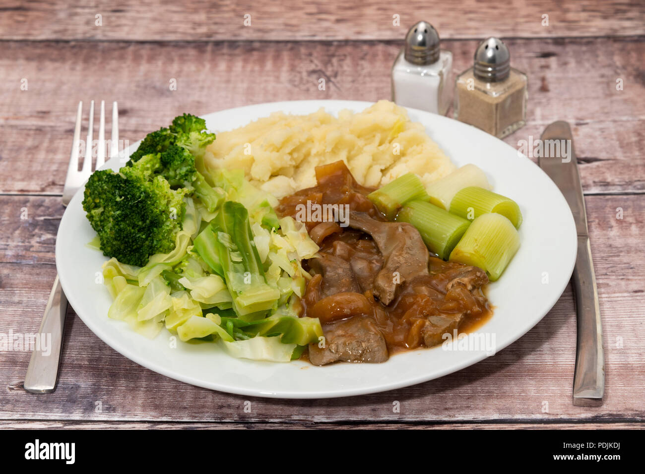A dinner of liver and onions with mashed potato and vegetables Stock