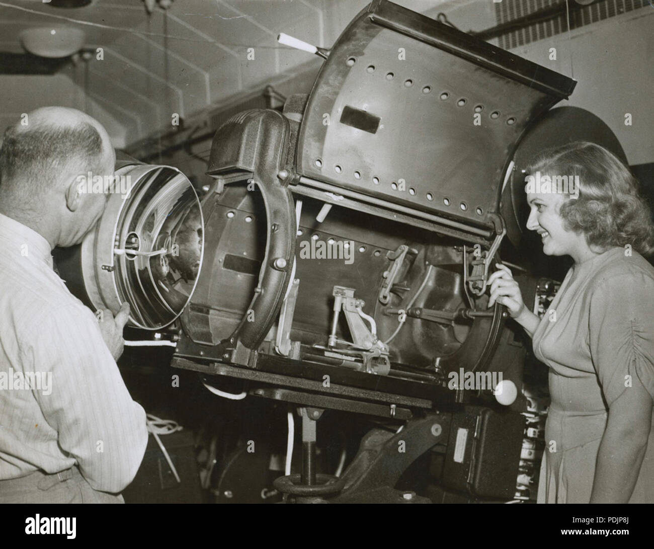 55 Harry Pike and unidentified woman looking at a Centrex projector, 1940 - 1949 (4773149205) Stock Photo