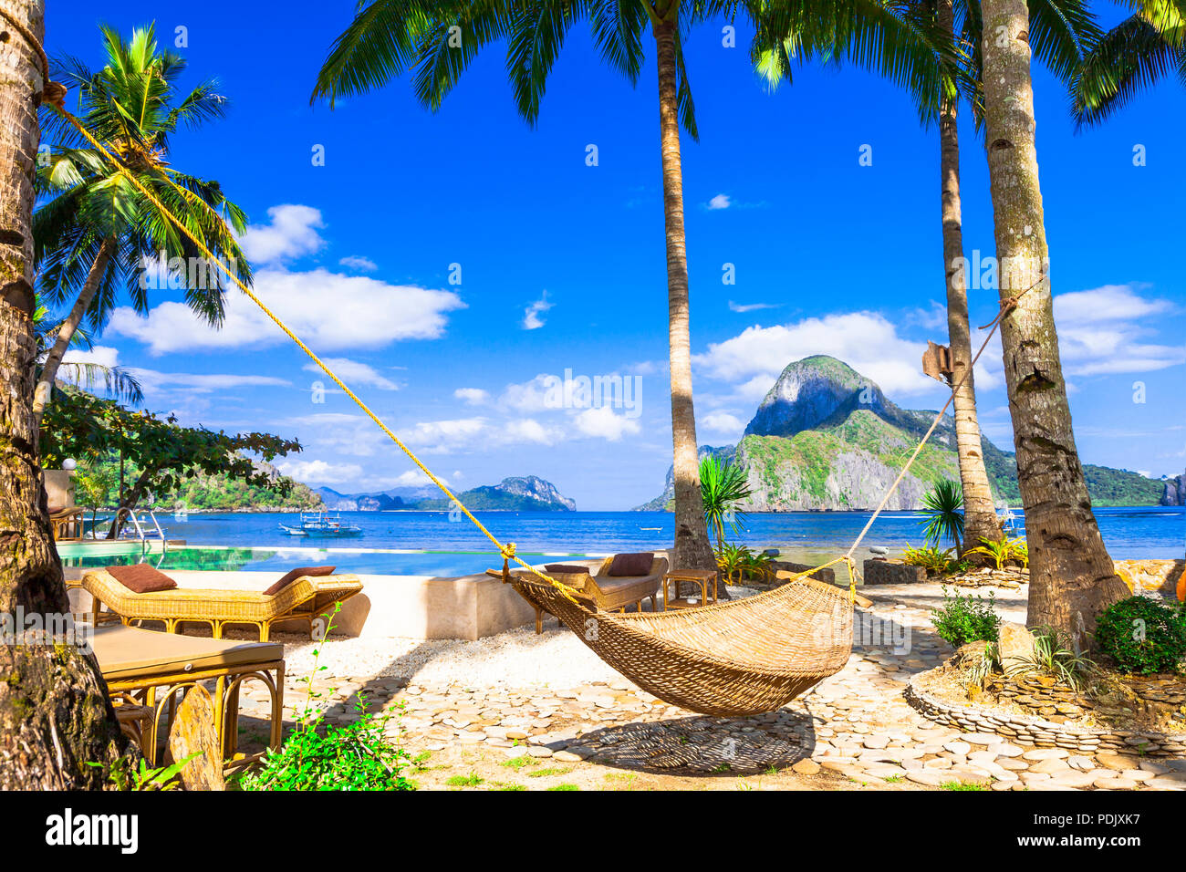 Tropical paradise in El Nido,view with palm trees and hammock,Philippines. Stock Photo