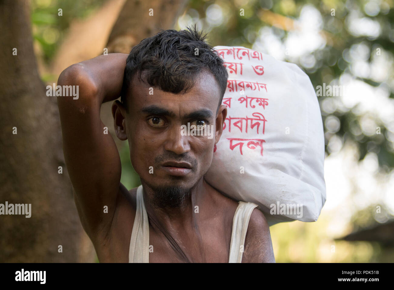 A Rohingya refugee returning to camp with relief materials at Balukhali in Ukhia, Cox's Bazar, Bangladesh Stock Photo