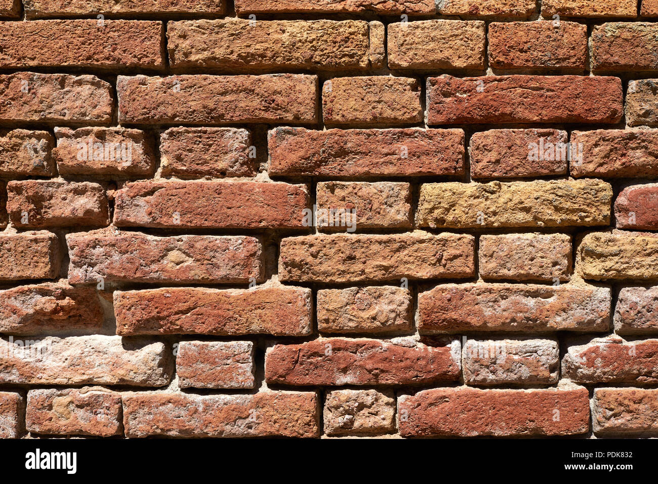 Old brick wall texture background closeup, sunlight Stock Photo