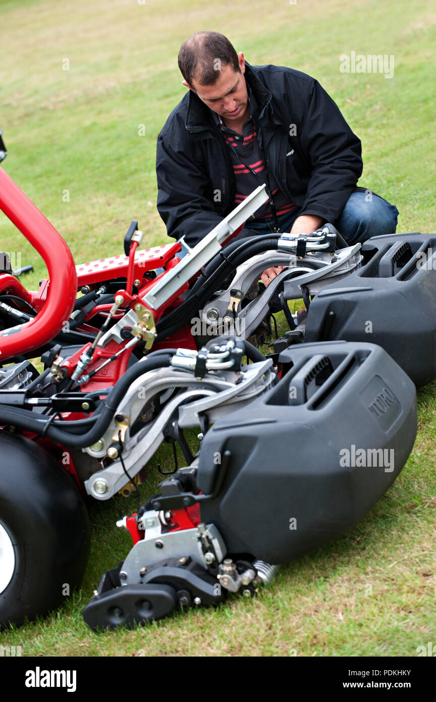 A Customer looking at a two gang reel mower at the Conference for groundsmen and park managers at the Royal Windsor Racecourse in Windsor, UK. Stock Photo