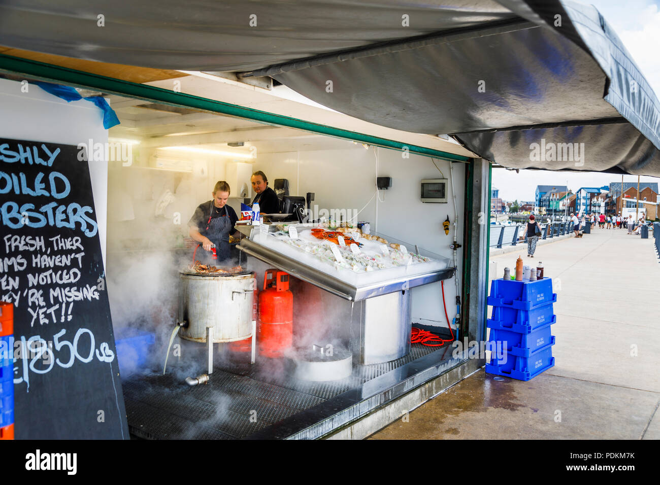 Stall steaming crabs and selling fresh seafood on display in Littlehampton, a small holiday resort on the south coast in West Sussex, UK in summer Stock Photo