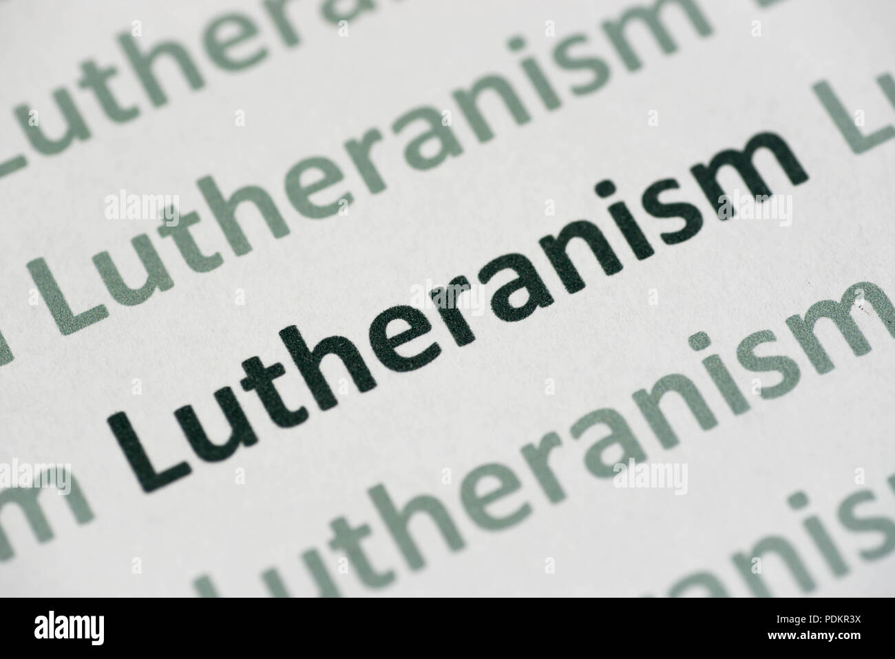word Lutheranism  printed on white paper macro Stock Photo