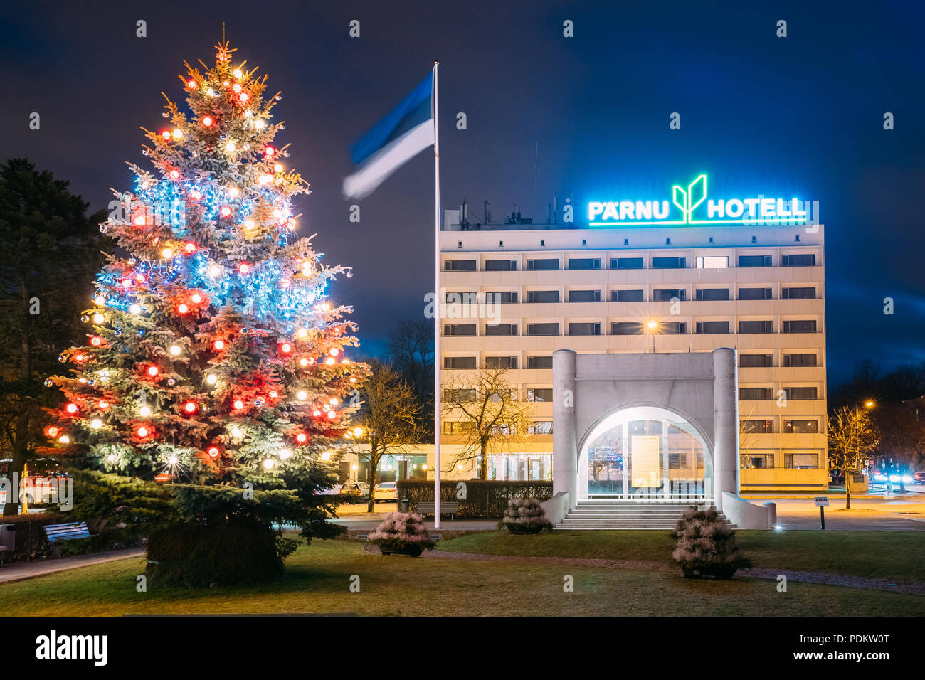 Parnu, Estonia - December 14, 2017: Parnu Hotel And Christmas Tree In Evening Christmas Xmas New Year Illuminations. Stock Photo