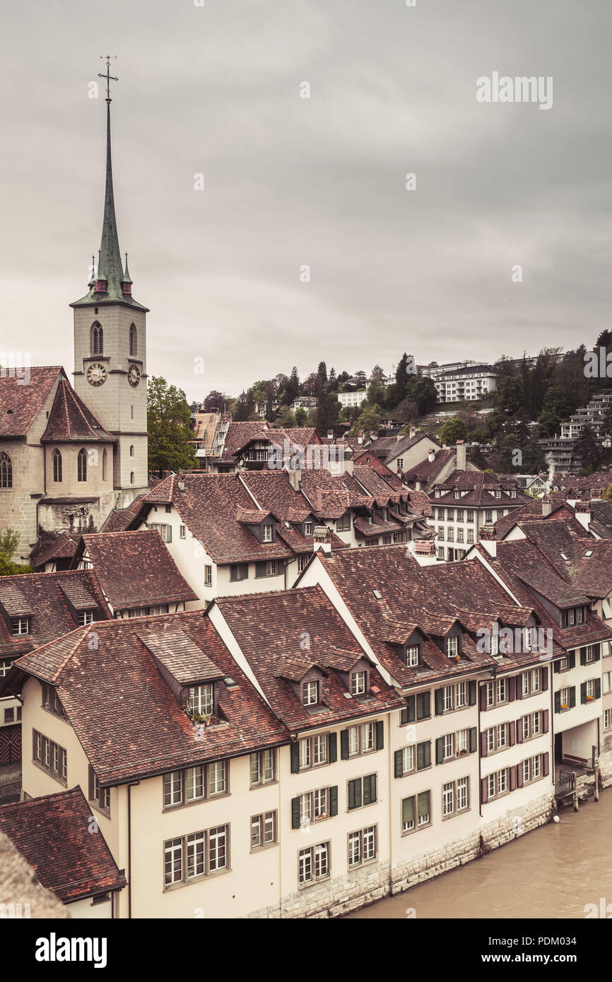 Bern old town, Switzerland. Cityscape with Nydeggkirche spire. Vintage toned vertical photo Stock Photo