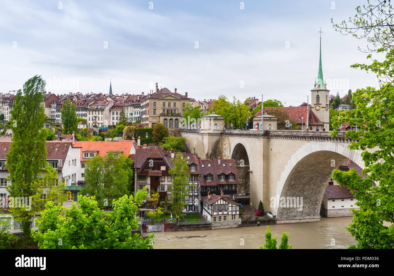 Bern old town, Switzerland. Cityscape with stone Nydeggbrucke bridge and Nydeggkirche spire Stock Photo