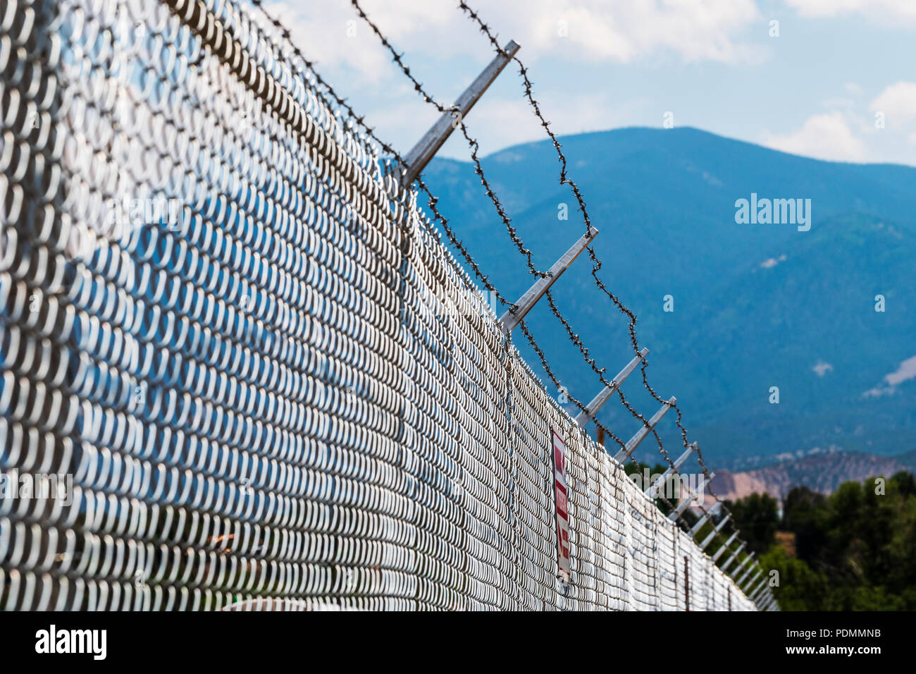 Cyclone fence & barbed wire; industrial site; Smeltertown, near   Salida; Colorado; USA Stock Photo