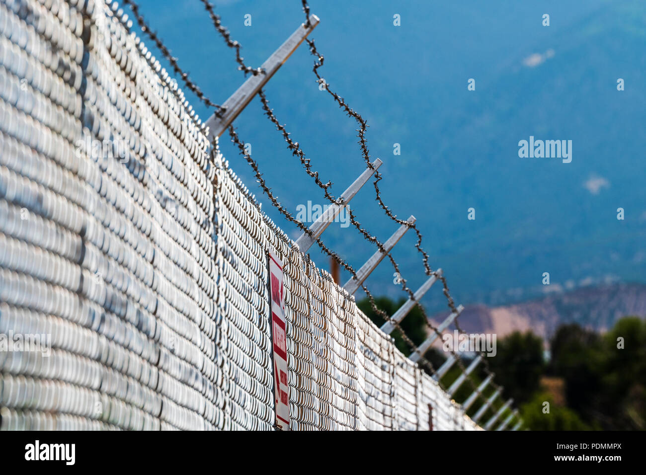 Cyclone fence & barbed wire; industrial site; Smeltertown, near   Salida; Colorado; USA Stock Photo