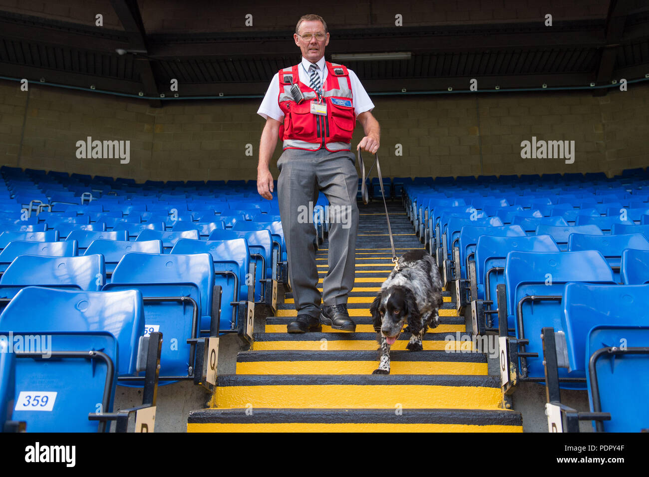 Sniffer dog Charlie and handler Frank Thornborrow check the stands at