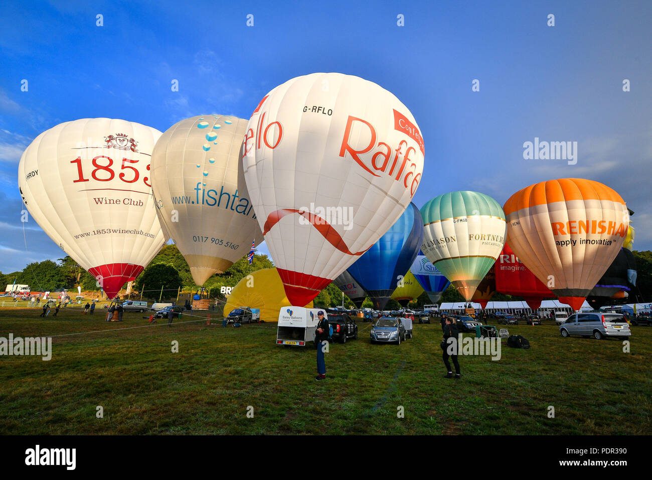Balloons inflate during a ground tether flight after bad weather prevented flying at the Bristol International Balloon Fiesta at the Ashton Court Estate in Bristol. Stock Photo