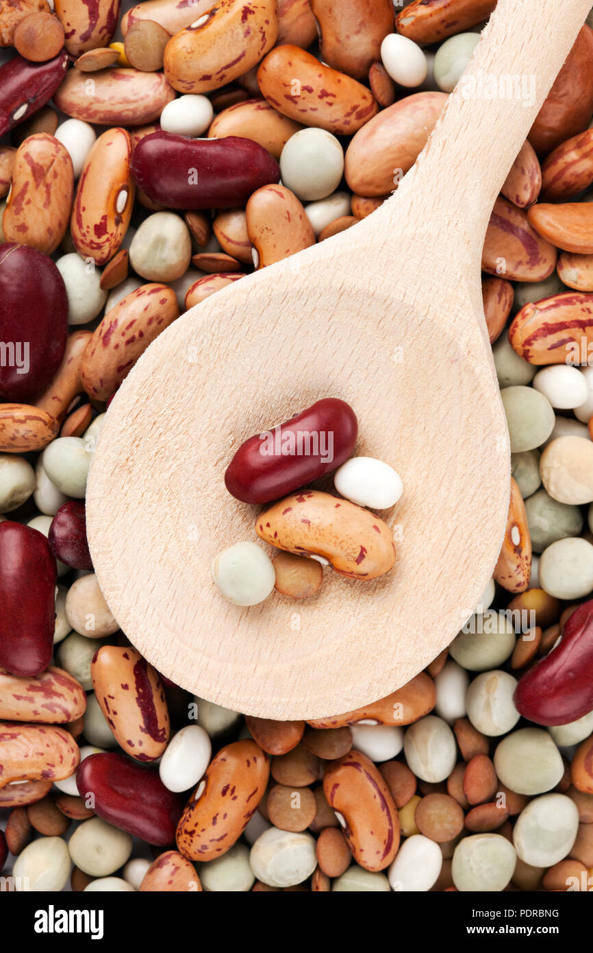variety of legumes on wooden spoon and in background Stock Photo