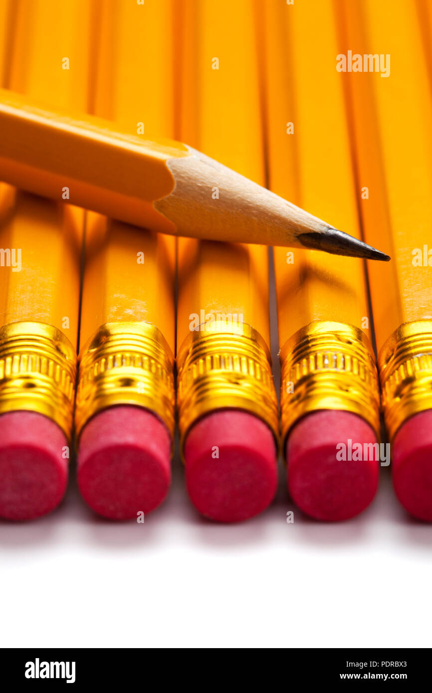 close up of sharpened pencil tip on row of yellow pencils Stock Photo