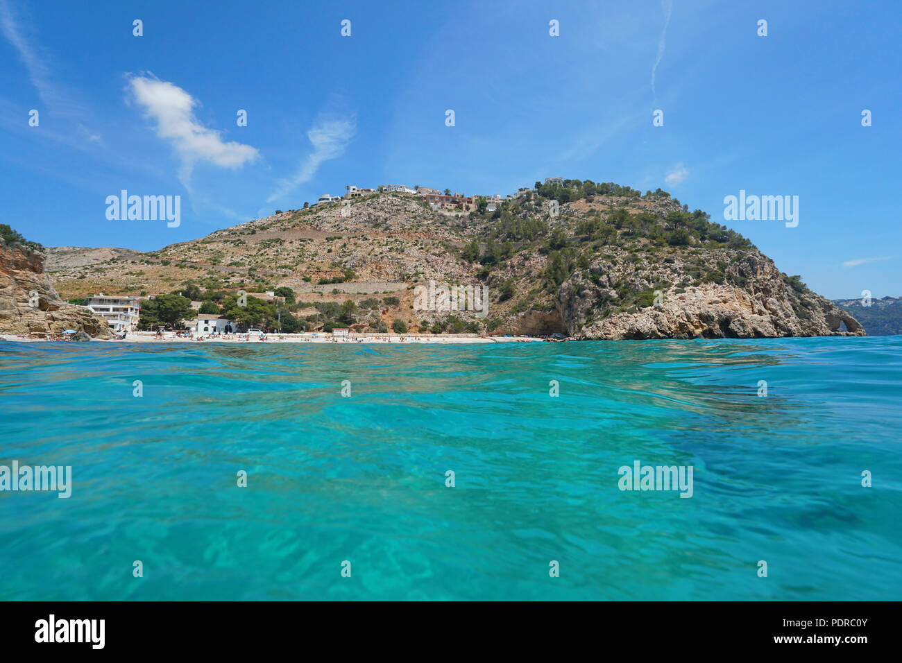 Spain Mediterranean coastline, beach and rocky coast in Cala Granadella seen from sea surface, Javea, Costa Blanca, Alicante, Valencia Stock Photo