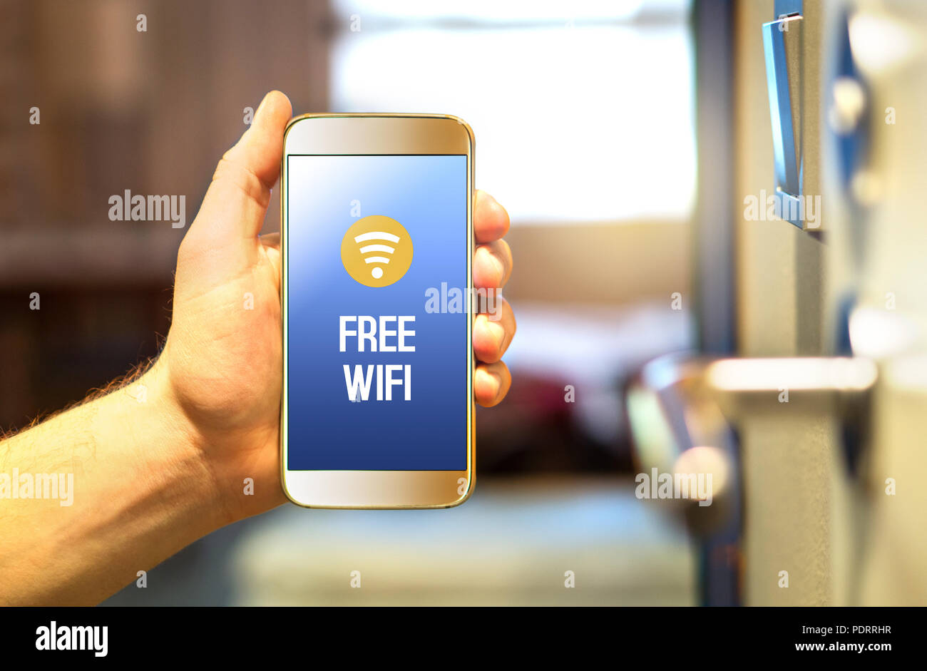 Free hotel wifi on smartphone in hotel room. Public internet access and connection available for customers, visitors and tourists. Hand holding phone. Stock Photo