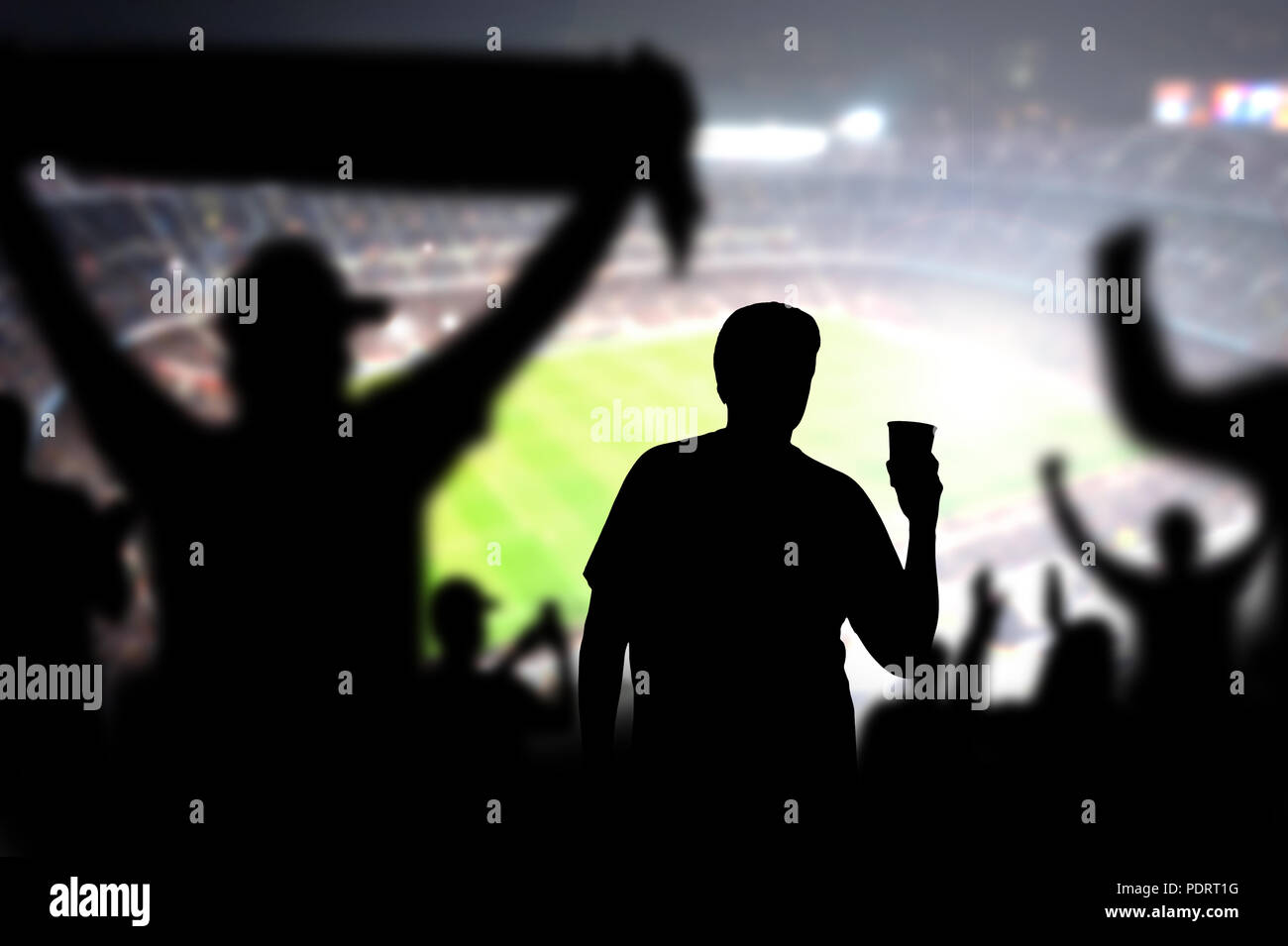 Football fan drinking beer in crowd in stadium. Man with alcohol