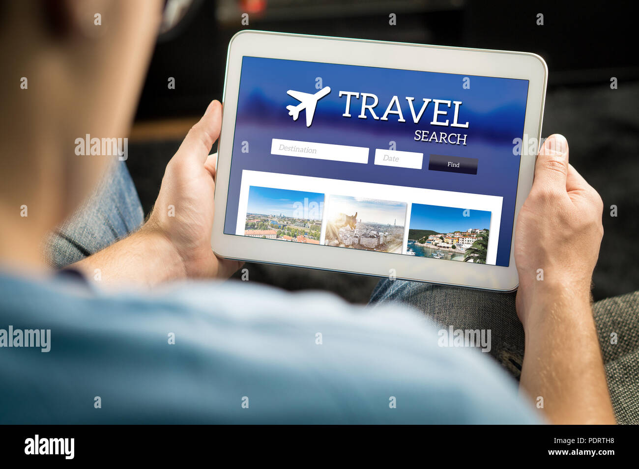 Man searching cheap flights, hotel or holiday package on internet by using online travel search application with tablet. Stock Photo