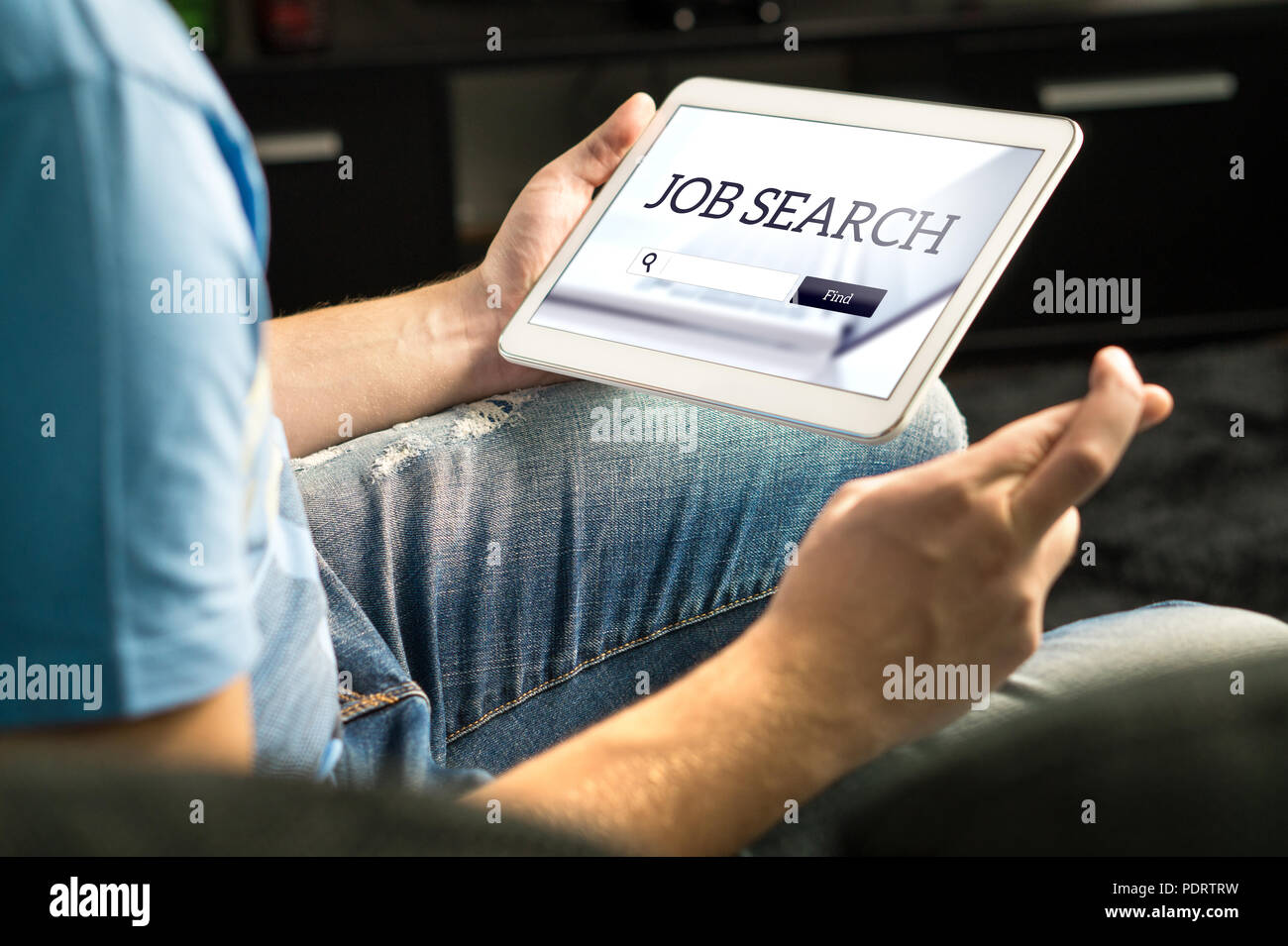 Happy job seeker trying to find work using online search engine home with tablet, Unemployment concept. Hopeful, motivated and excited man. Stock Photo