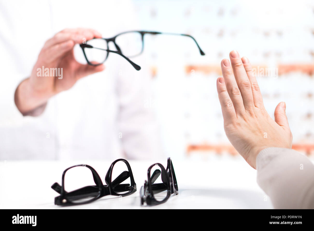 Problem at optician. Unhappy customer refuse to try or don't like new glasses. Bad service in spectacles store. Disappointed and angry patient. Stock Photo