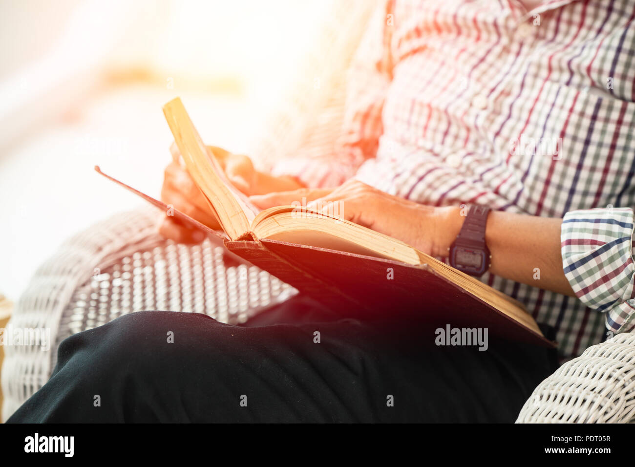 closeup elder man reading textbook for self education self study learning concept Stock Photo