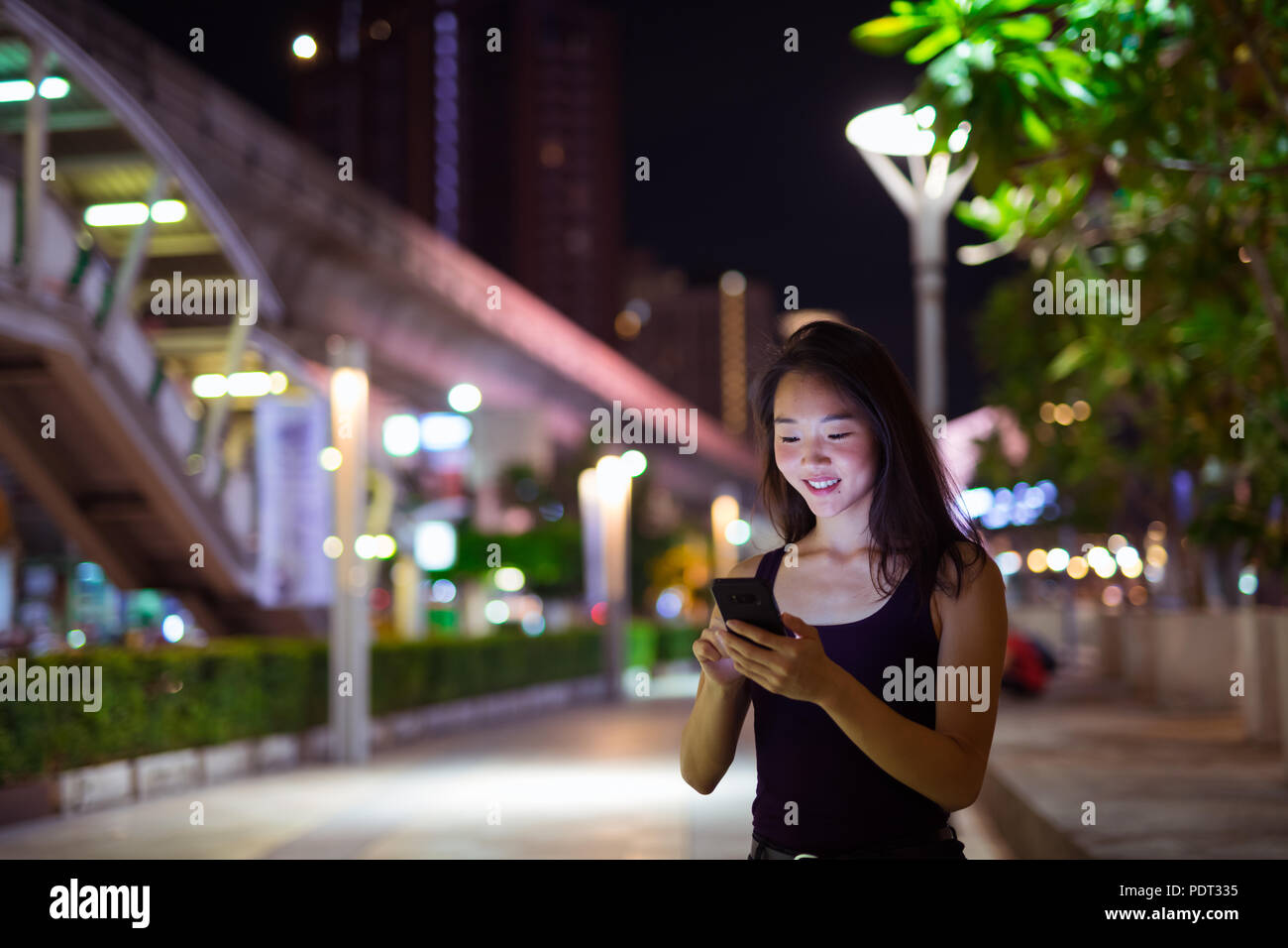 Beautiful Asian Woman Outdoors At Night Using Mobile Phone Stock Photo ...