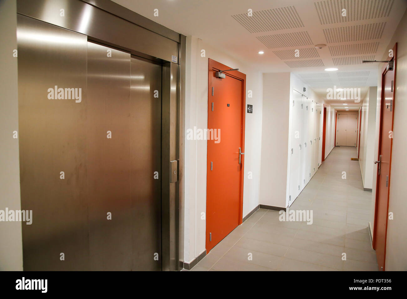 Lobby Of A New Building With An Elevator And A Staircase In A