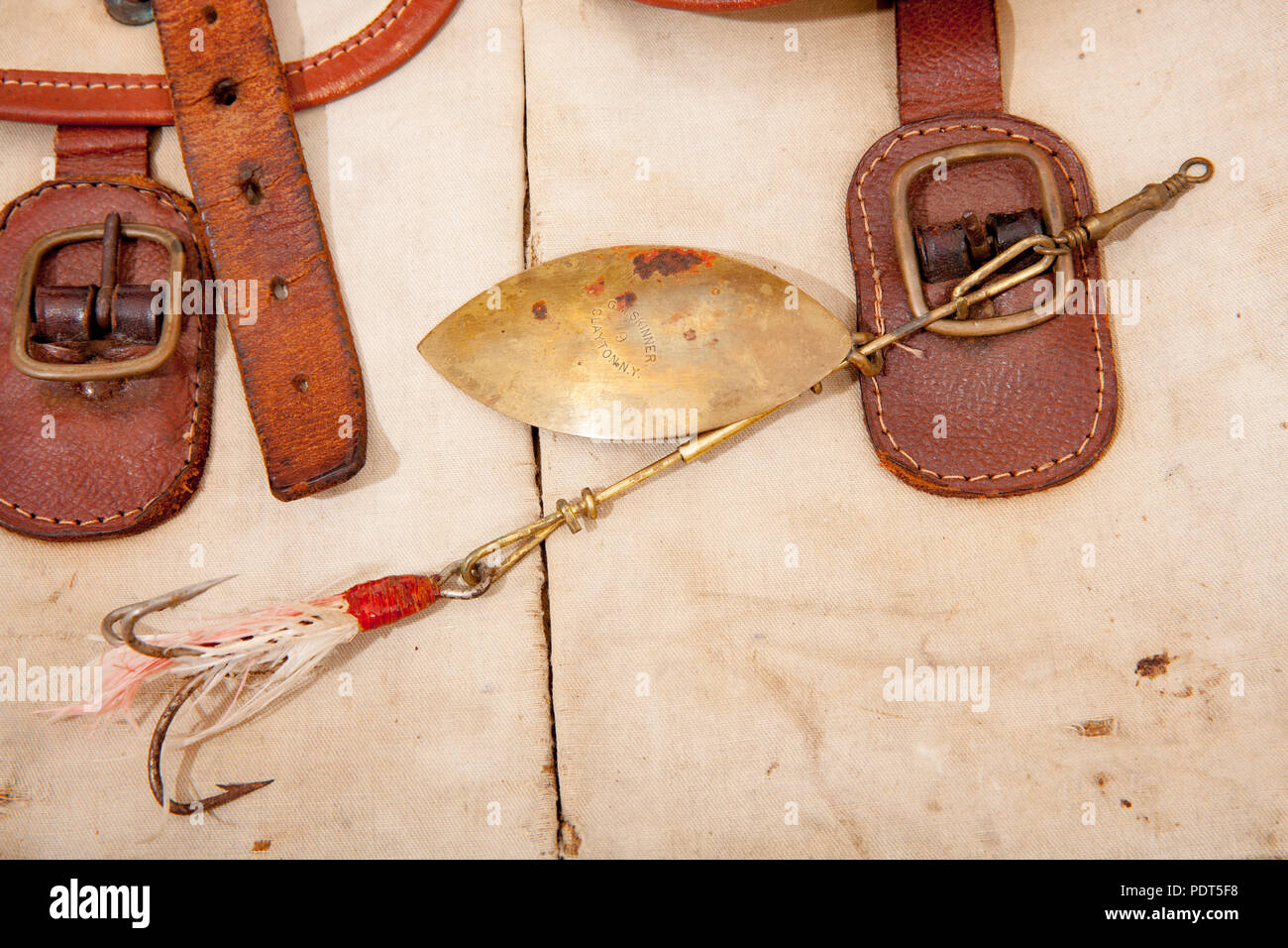 An old G.M. Skinner of Clayton N.Y. metal fishing lure displayed on an old  fishing bag. From a collection of vintage fishing tackle Dorset England UK  Stock Photo - Alamy