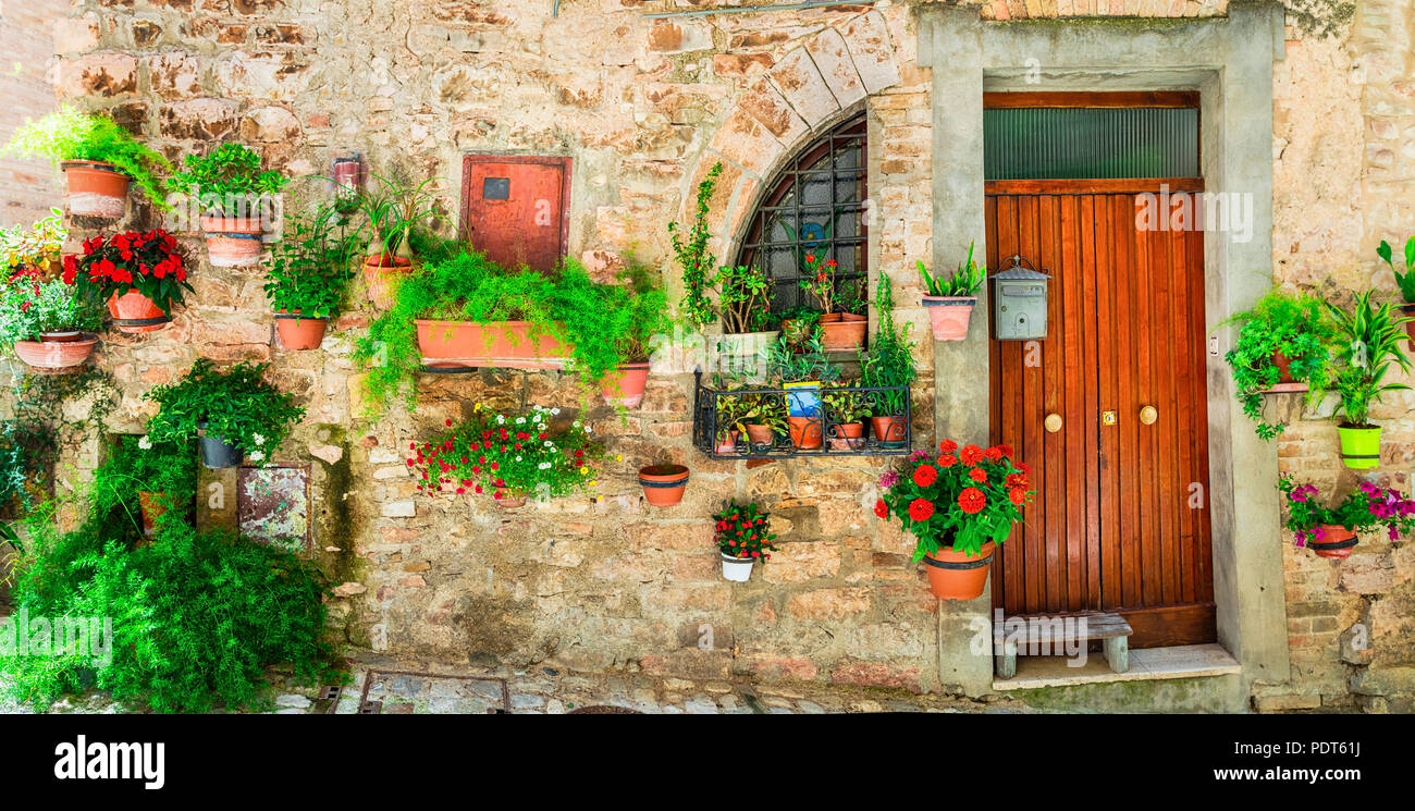 Old door and floral decoration in Spello village,Umbria,Italy. Stock Photo