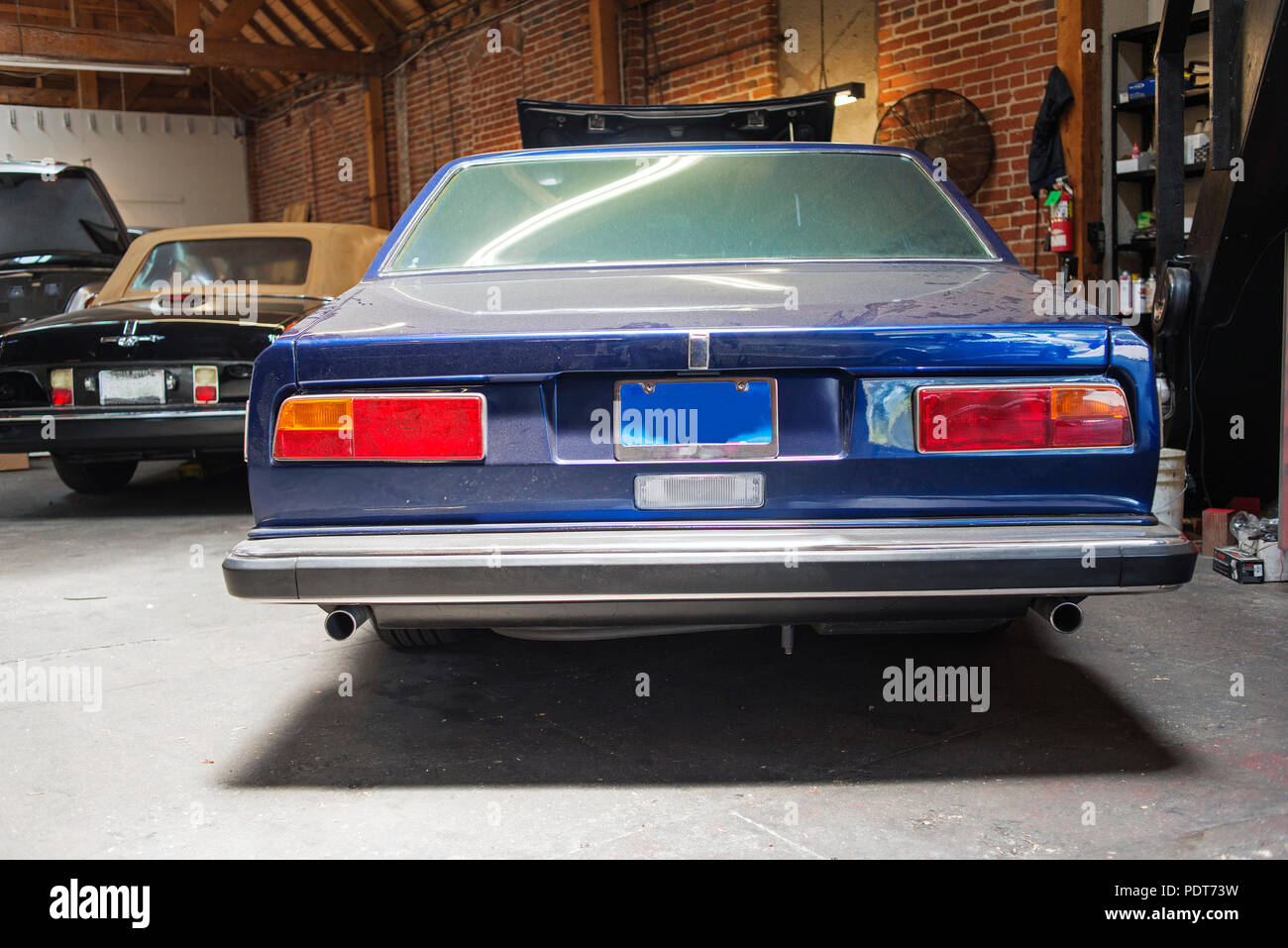 Restoule Rear View A rear view of a vintage classic car in a repair shop Stock Photo - Alamy