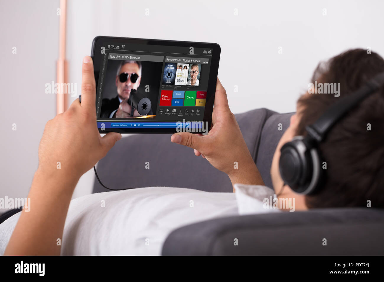 Man watching movie on website through digital tablet Stock Photo Alamy