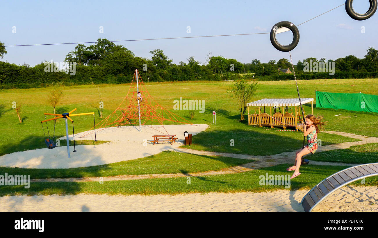 Kids, children playing on zip wire slide ride, France Europe kids
