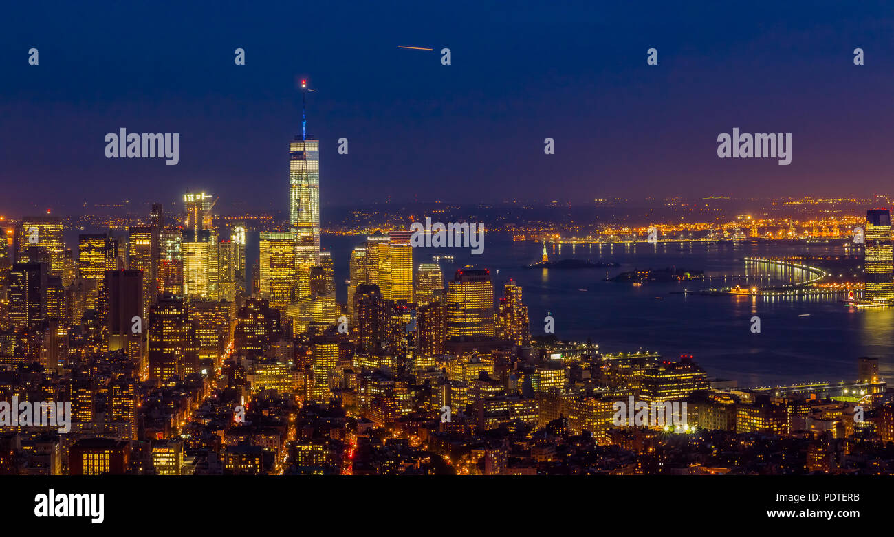 New York Downtown and lower Manhattan skyline view with the One World Trade Center skyscraper viewed from Empire State Building after sunset Stock Photo