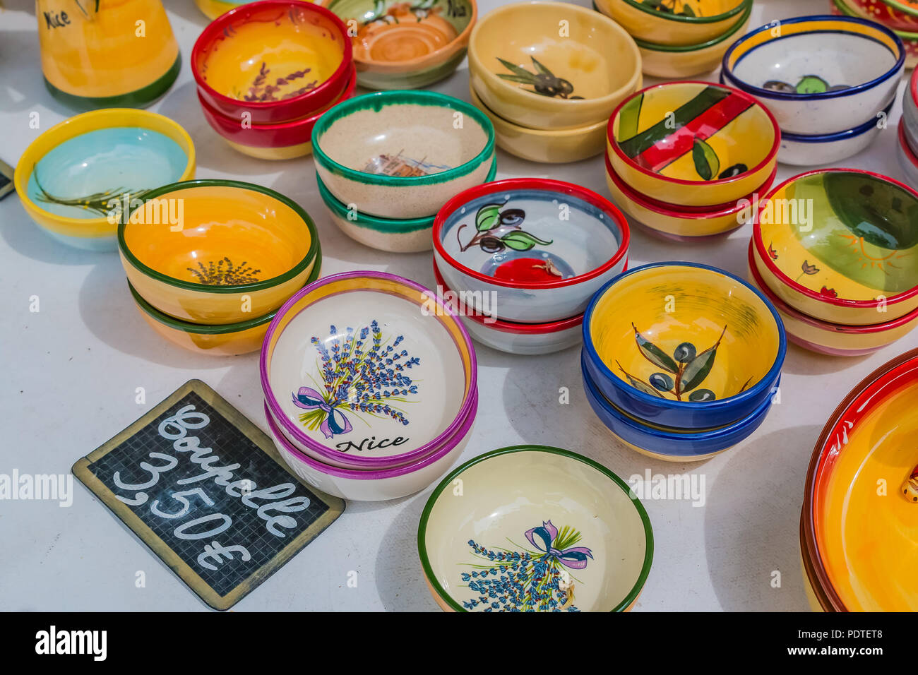 Colorful souvenir pottery dishes made of ceramics at a market stall at the Cours Saleya, famous market in Nice, that is known for hand made gifts, flo Stock Photo