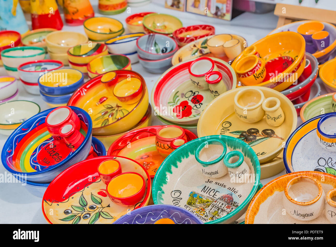 Colorful souvenir pottery dishes made of ceramics at a market stall at the Cours Saleya, famous market in Nice, that is known for hand made gifts, flo Stock Photo