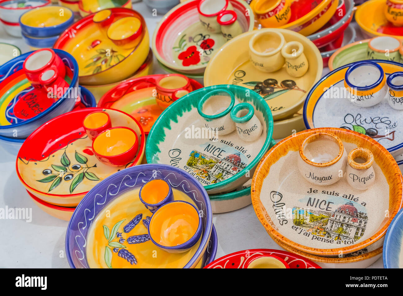 Colorful souvenir pottery dishes made of ceramics at a market stall at the Cours Saleya, famous market in Nice, that is known for hand made gifts, flo Stock Photo