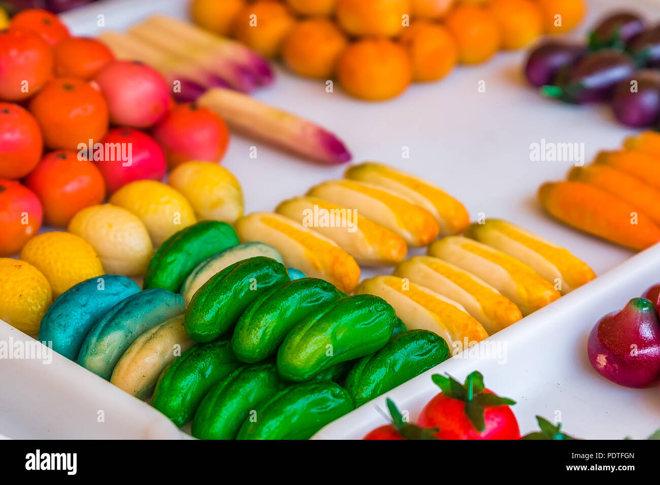 Colorful marzipan or almond paste candy made to look like fruits and vegetables and a market in Nice, France. Stock Photo