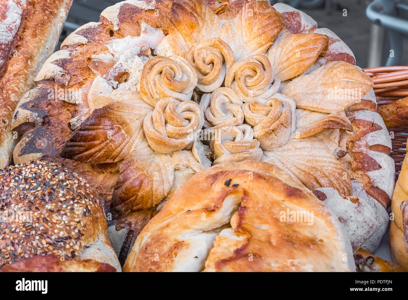 Selection of intriccately decorated fresh artisan french bread in a