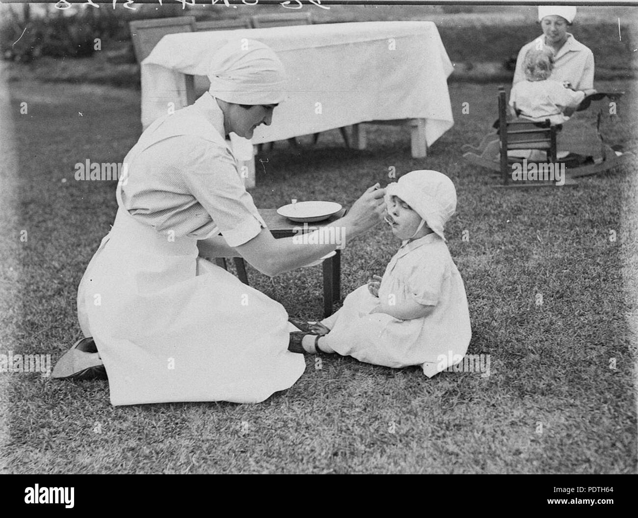 169 SLNSW 51461 Nursing staff and children Stock Photo