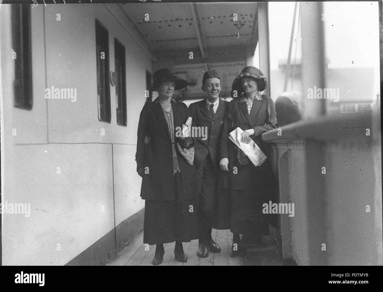 191 SLNSW 8638 A shipboard picture of Miss Elizabeth Neate left and Mrs Florence Messenger both of Glenelg South Australia with young man Stock Photo