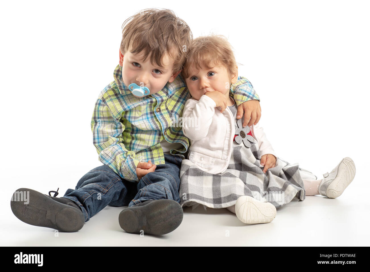 Portrait of adorable happy brother and sister smile and laugh together with funny positive expression on their faces. Kids having fun time hugging, ma Stock Photo