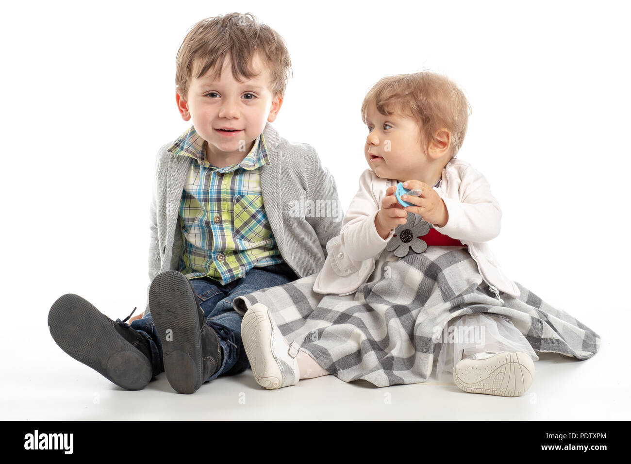 Portrait of adorable happy brother and sister smile and laugh together with funny positive expression on their faces. Kids having fun time hugging, ma Stock Photo
