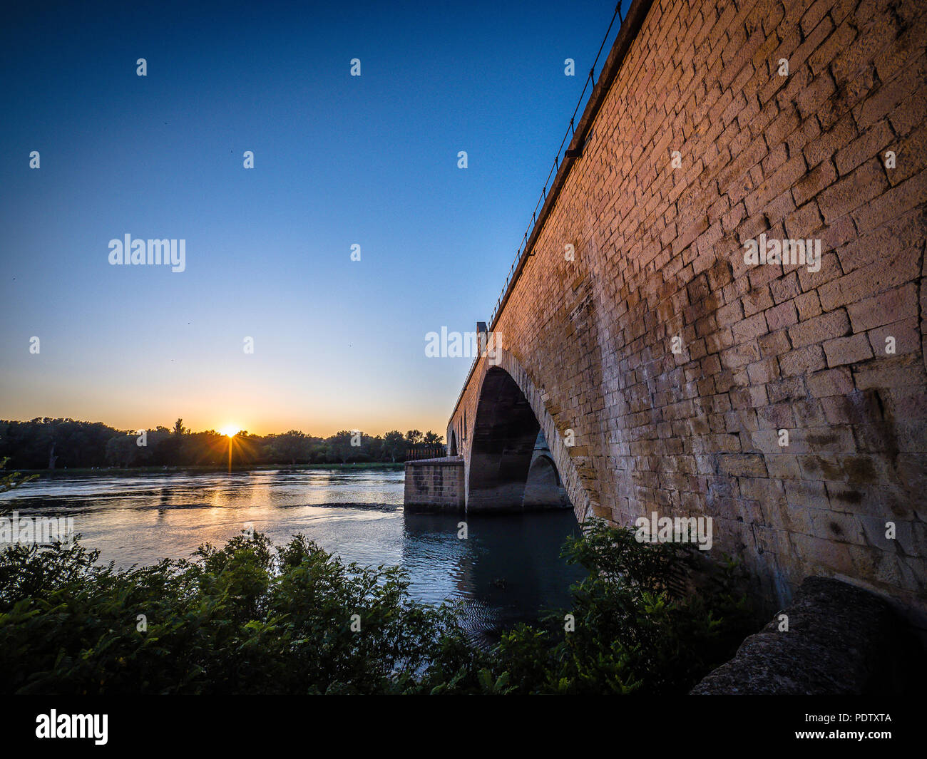 Scenic view of Avignon Bridge Pont d'Avignon during sunset magic hour Stock Photo