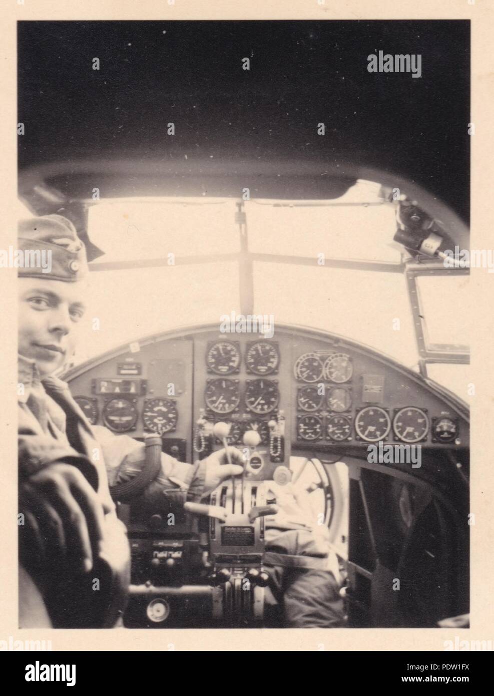 Image from the photo album of Oberfeldwebel Karl Gendner of 1. Staffel, Kampfgeschwader 40: Karl Gendner sits in the Pilot's seat of a Heinkel He 111 E-1, while his Observer, Steiner, poses in the nose of the aircraft in 1938. Stock Photo