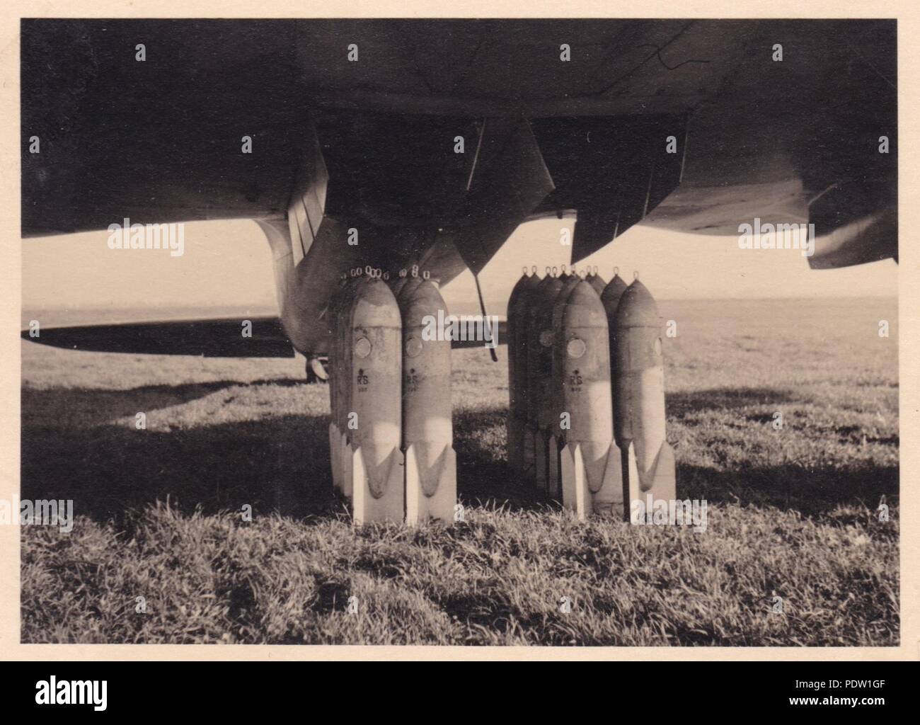 Image from the photo album of Oberfeldwebel Karl Gendner of 1. Staffel, Kampfgeschwader 40: Captioned simply as 'our payload', bombs wait to be loaded into a Heinkel He 111E-1 of 8./KG 355 at Giebelstadt Airfield, Bavaria in 1938. Stock Photo