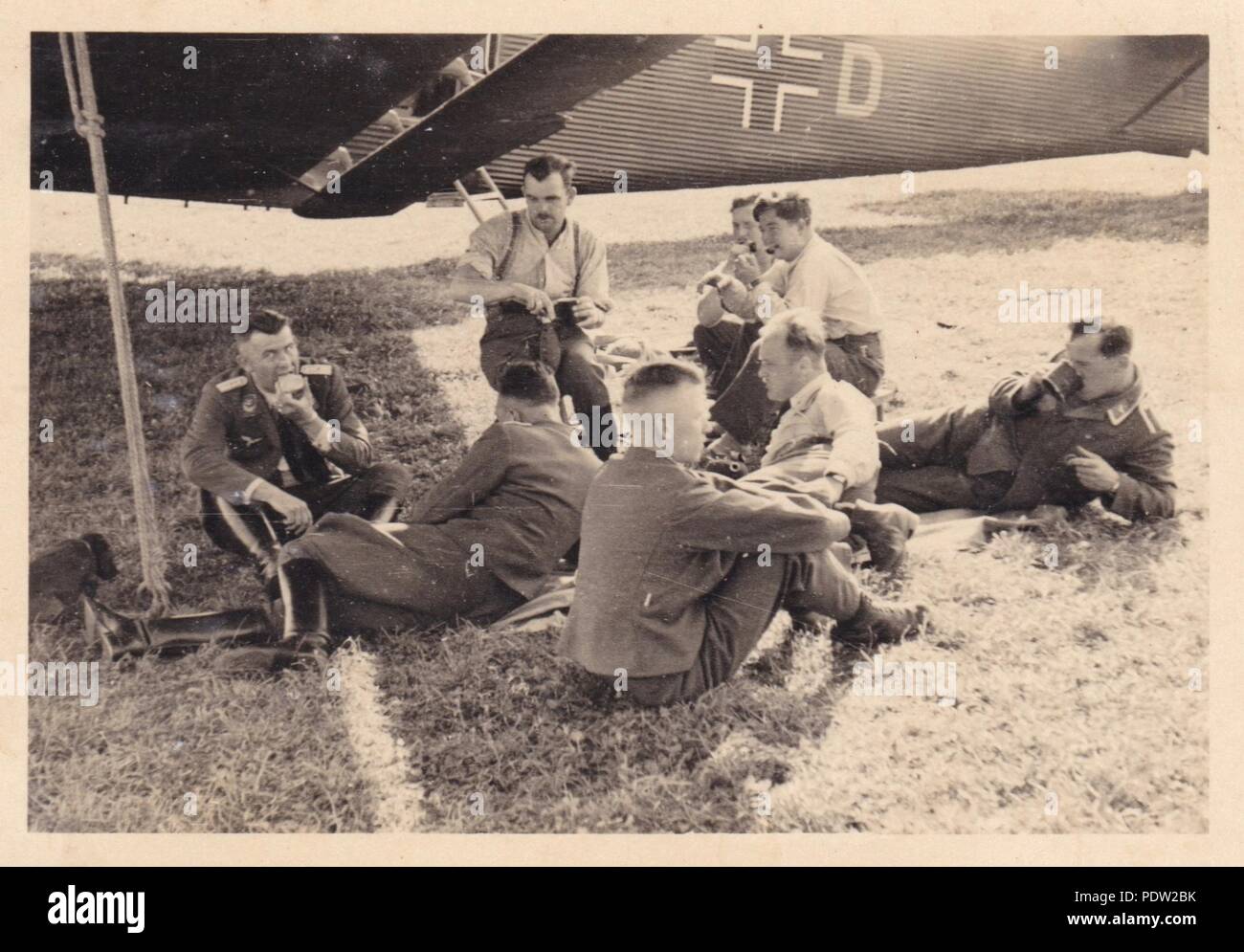 Image from the photo album of Oberfeldwebel Karl Gendner of 1. Staffel, Kampfgeschwader 40: Karl Gendner (on the right at the back) and other transport crewmen from 3./KGzbV 9 relax between missions beside their Junkers Ju52/3m transport aircraft at Krakow Airfield, Poland in September 1939. Stock Photo