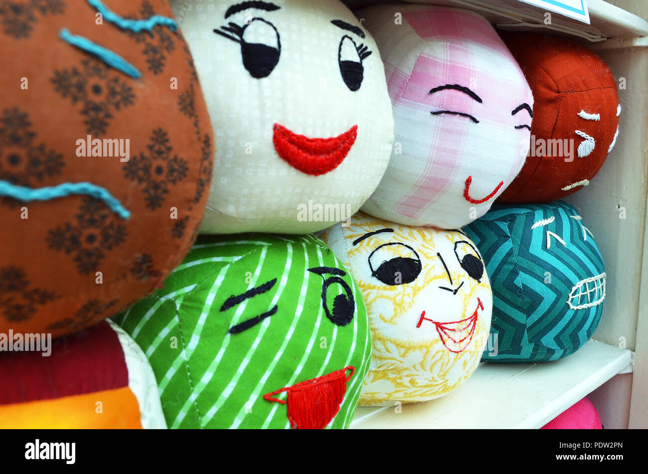 Different human expressions and emotions portrayed on pillows Stock