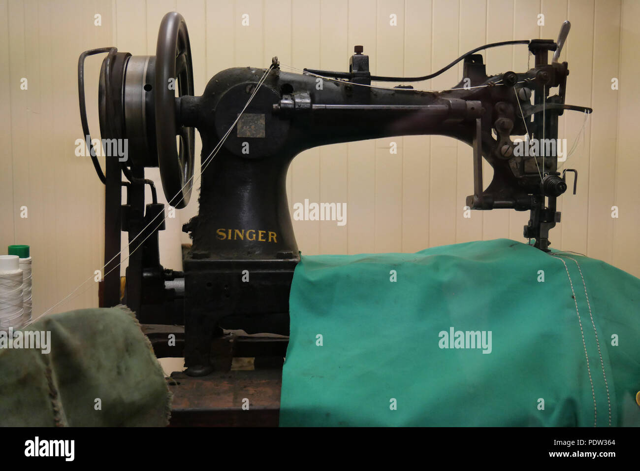 National Waterways Museum, Ellesmere Port, Cheshire, CH65 4FW, UK. Aug- 02 2018 - Old Singer Sewing Machine with Can-vas Sail Sheet being worked on. Stock Photo