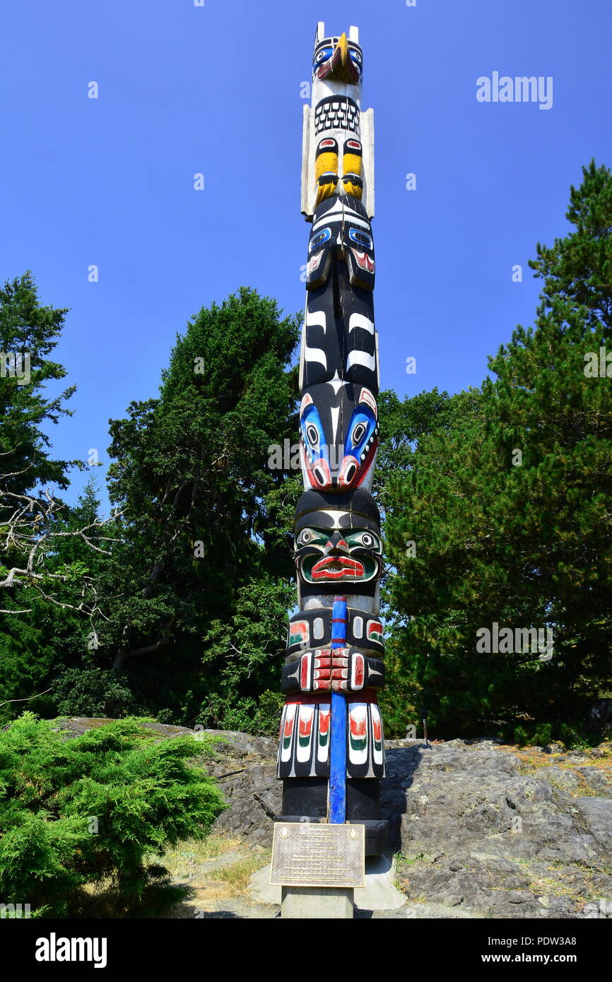 First Nations totem pole on the grounds of Government House in Victoria BC, Canada Stock Photo