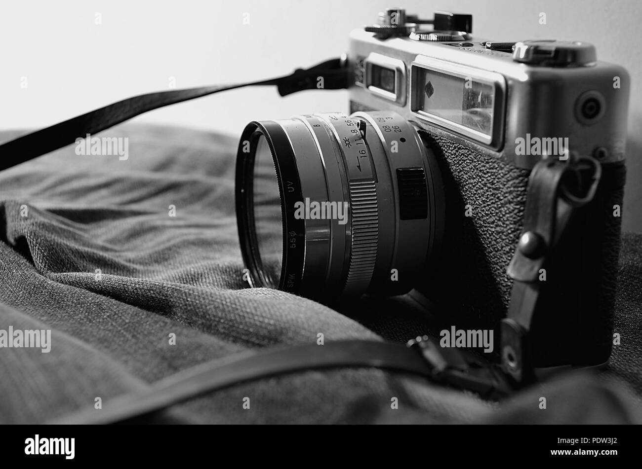 Traveller: Old SLR Camera and old jeans Stock Photo